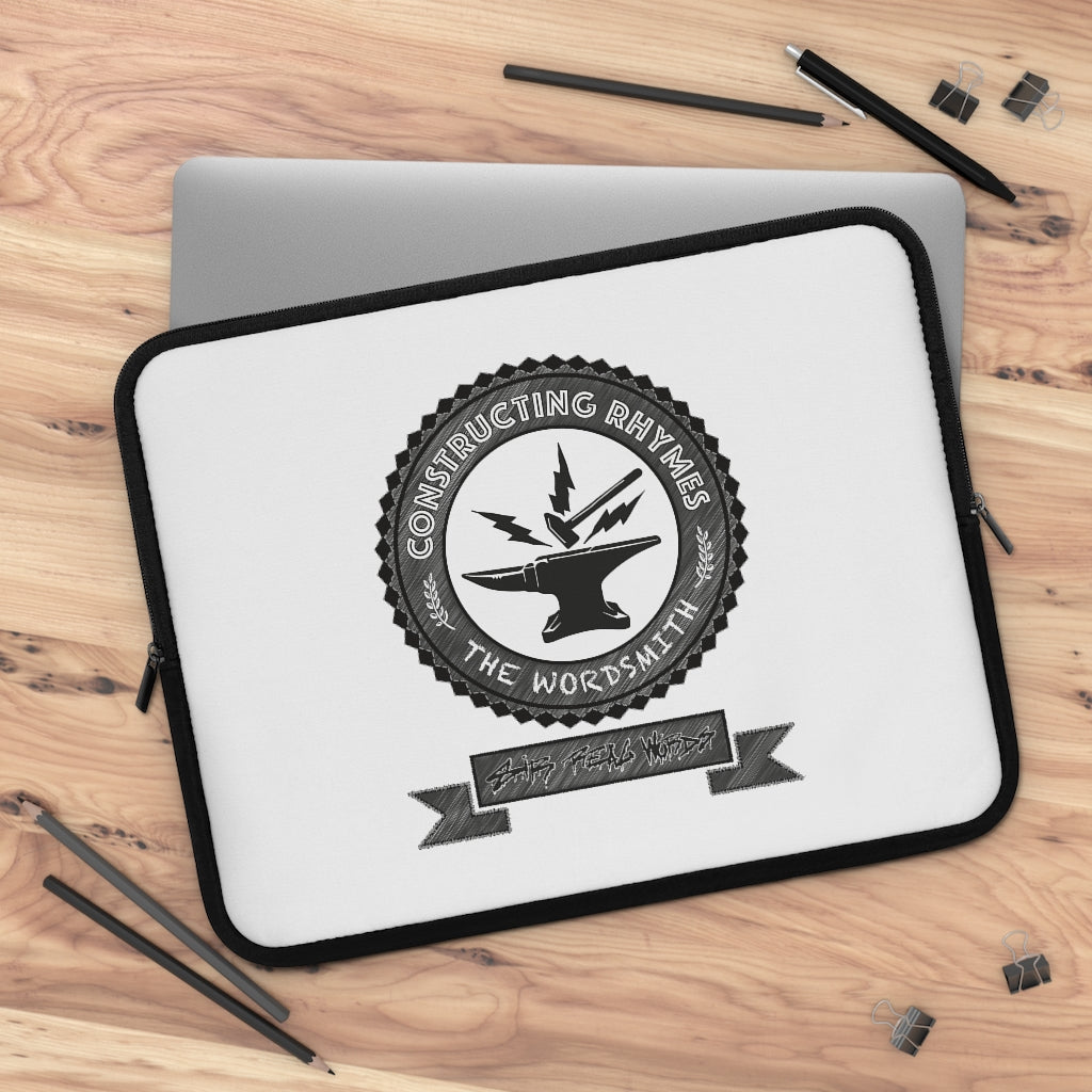 THE WORDSMITH - CONSTRUCTING RHYMES - (Top down desk view) Black & White Laptop Sleeve with a hammer and anvil letting the sparks fly. A circular shield design comprising of both graphic and typographic art. Designed by Sir Real Words for Sir Real Digital. 